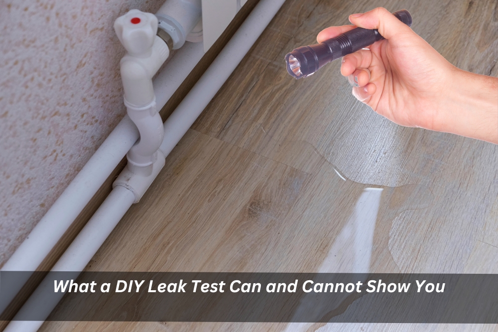 Shining a flashlight on a water puddle near pipes to detect a leak