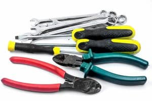 Toolsfor removing a stuck tap handle, including pliers, screwdrivers, wrenches, and wire cutters.