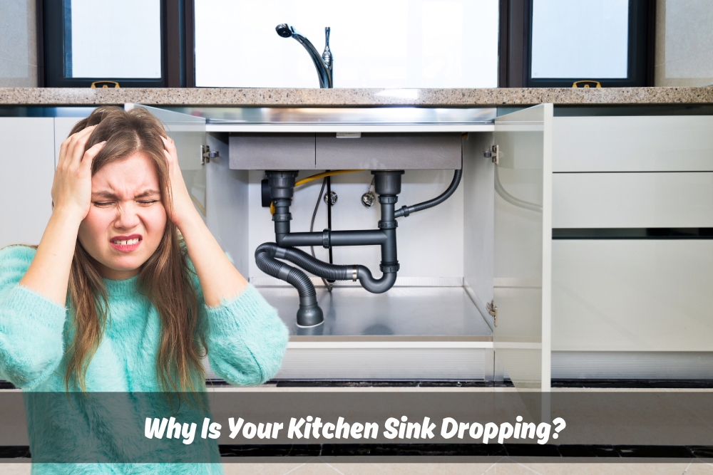 Frustrated woman holding her head in front of an open cabinet with visible plumbing, illustrating a common household problem of a kitchen sink dropped from its original position.