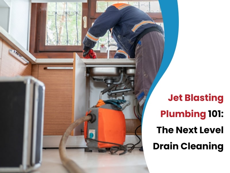 An image of a plumber using jet blasting equipment to clean a kitchen drain - Jet Blasting Plumbing 101: Next Level Drain Cleaning.