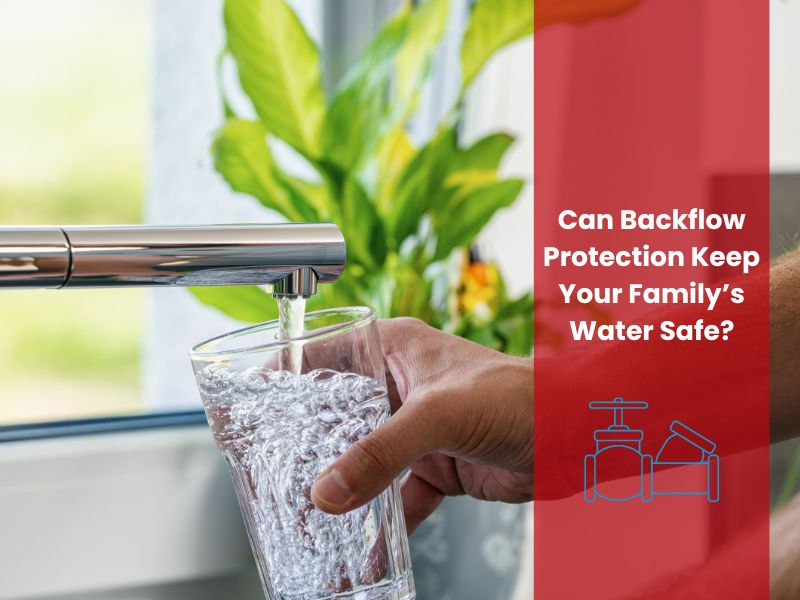 Hand filling a glass of water from a faucet, highlighting the importance of backflow protection for safe drinking water.