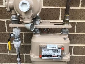 Gas installation with leak detected using foam bubbles, following gas installation regulations for safety.