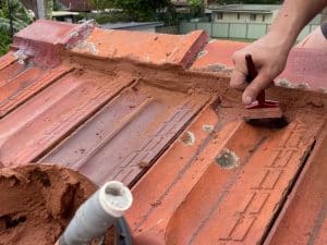 Repairing tile roof to prevent future leaking roof damage and deterioration of roofing structure.