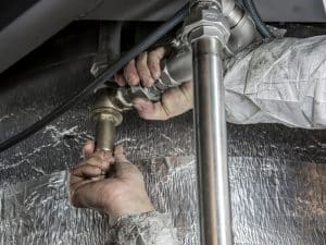 a plumber fixing a type of pipe to maintain its function