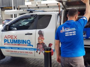 A plumbing vehicle showing tools for addressing tree roots in drainage pipes with professional plumbing services contact details.