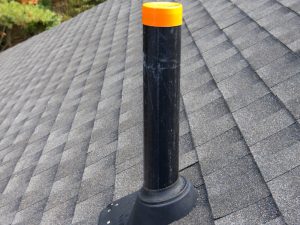 Plumbing vent on a roof, a potential hidden cause of a smelly drain in residential properties.