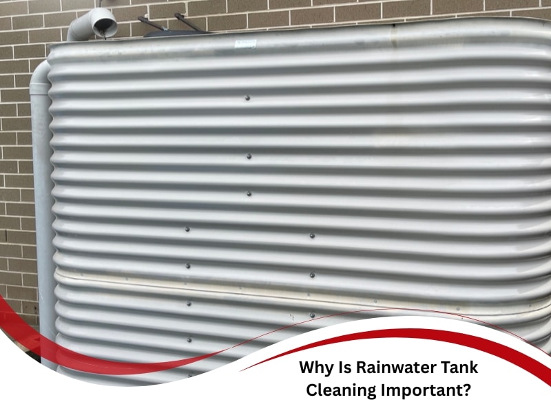 Corrugated metal rainwater tank beside brick wall, highlighting rainwater tank cleaning necessity.