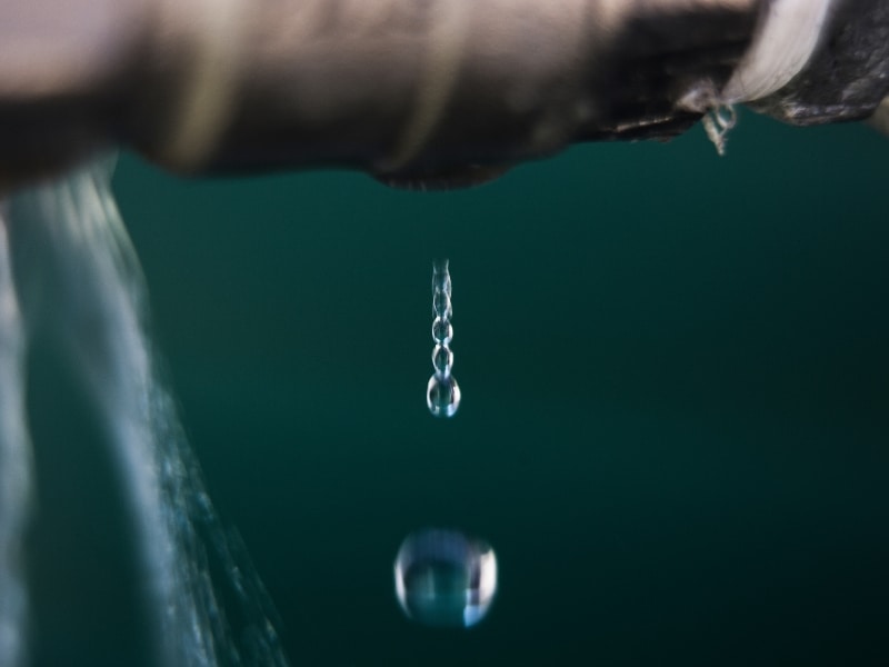 Leak detection solution identifying dripping water from damaged pipe.