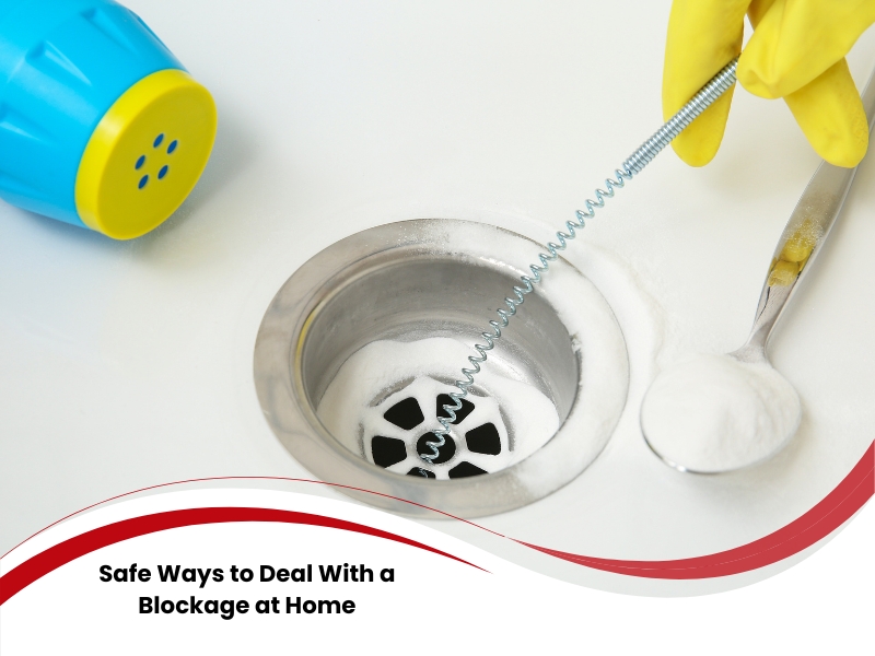 Using a drain snake and baking soda to clear a blocked sink drain