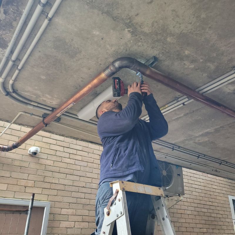 Gas plumber conducting a safety inspection on residential gas lines