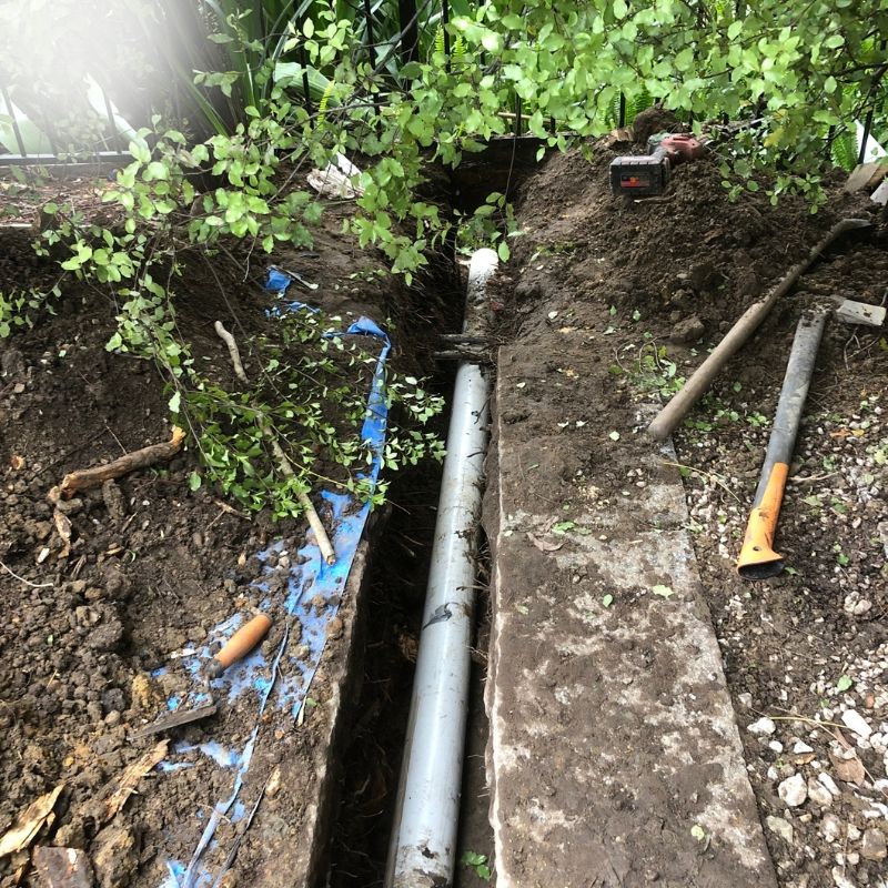 Excavated drain line exposed for diagnosis after repeated blockages before relining