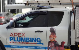 A branded Apex Plumbing service ute with ladder rack and signage parked on a street, representing a professional Plumber Sydney service.
