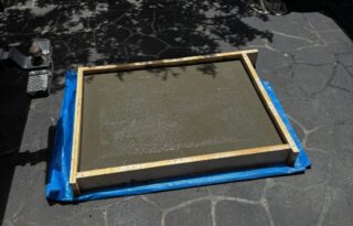 Stormwater pit screen catching silt and debris to prevent repeat stormwater blockage